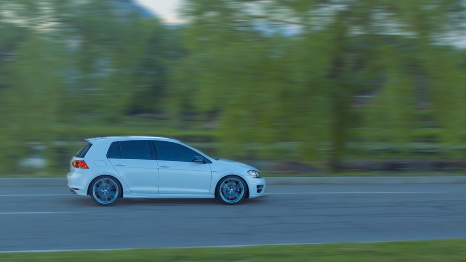 Panning shot of a Volkswagen Golf R driving.